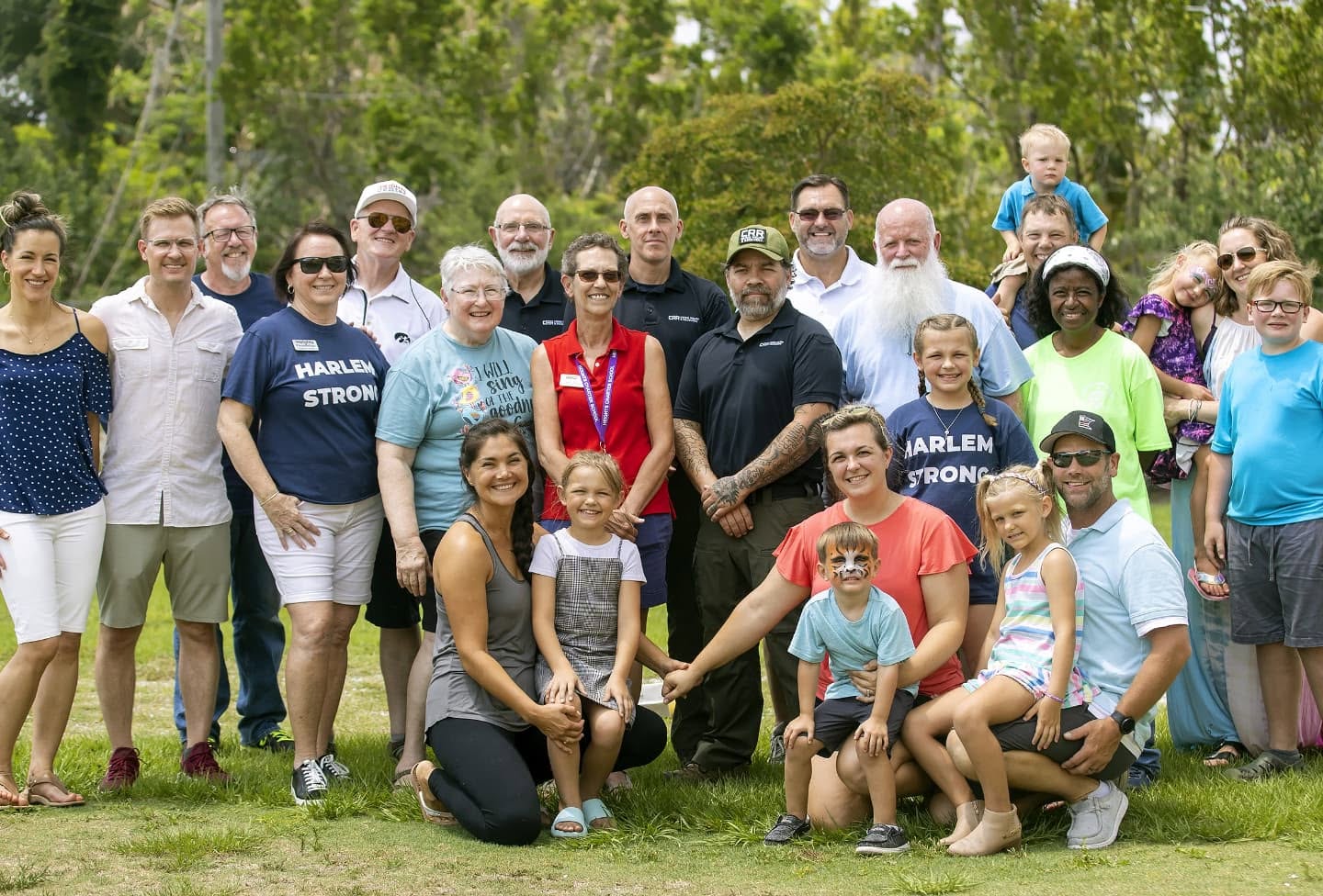 Adventures Relief team and volunteer families gathered outdoors for a group photo