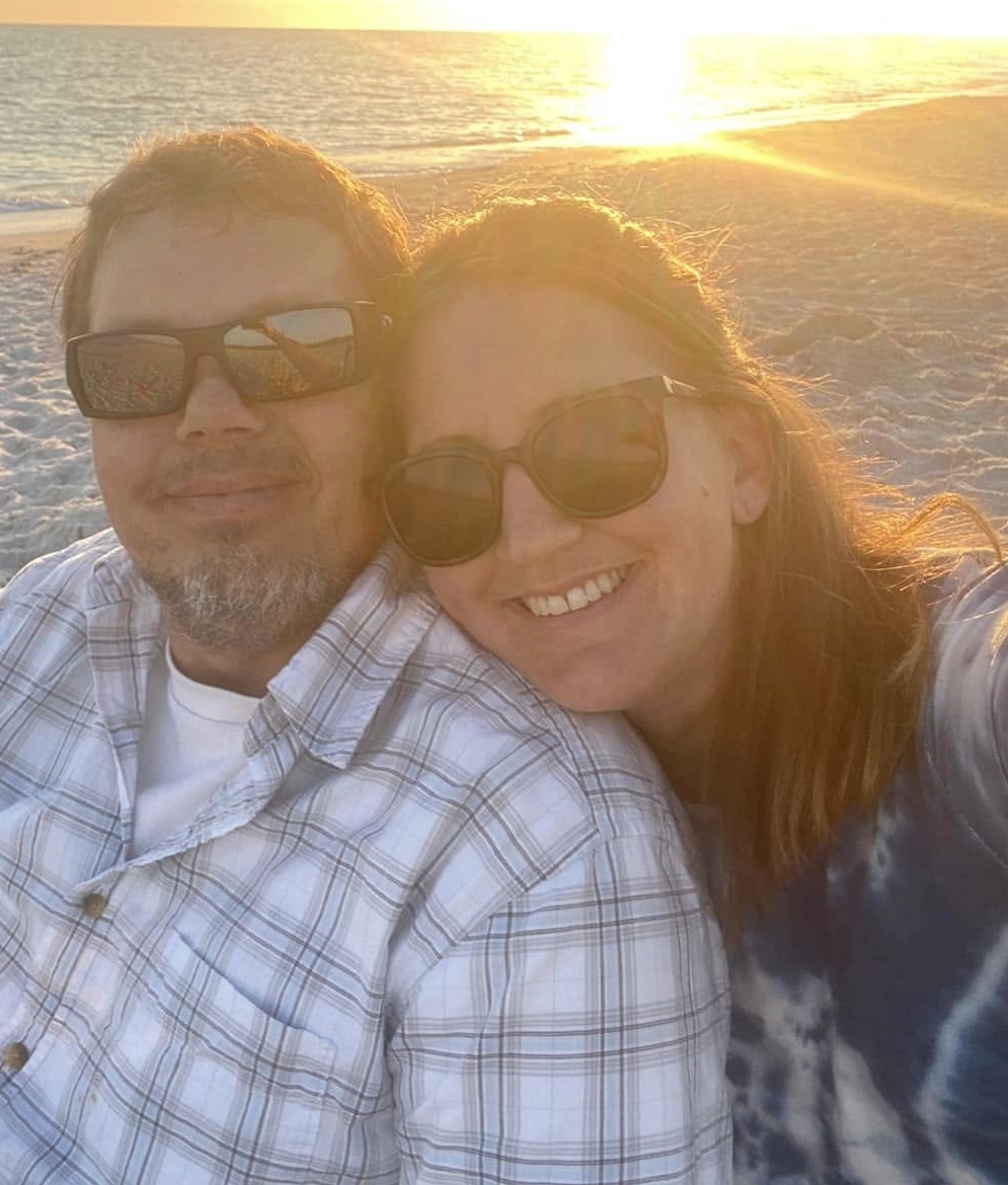 Mitch and Jen Narveson together on the beach at sunset